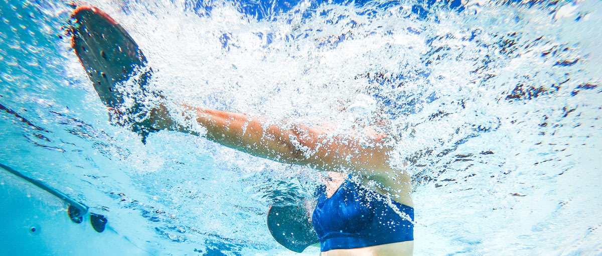 Underwater shot of a woman doing aquatic resistance exercises