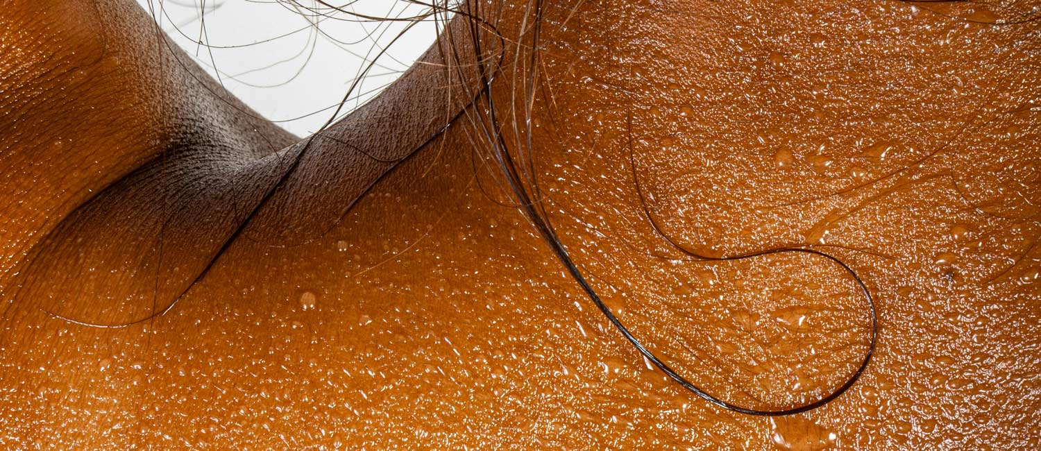 beads of sweat on a woman's back