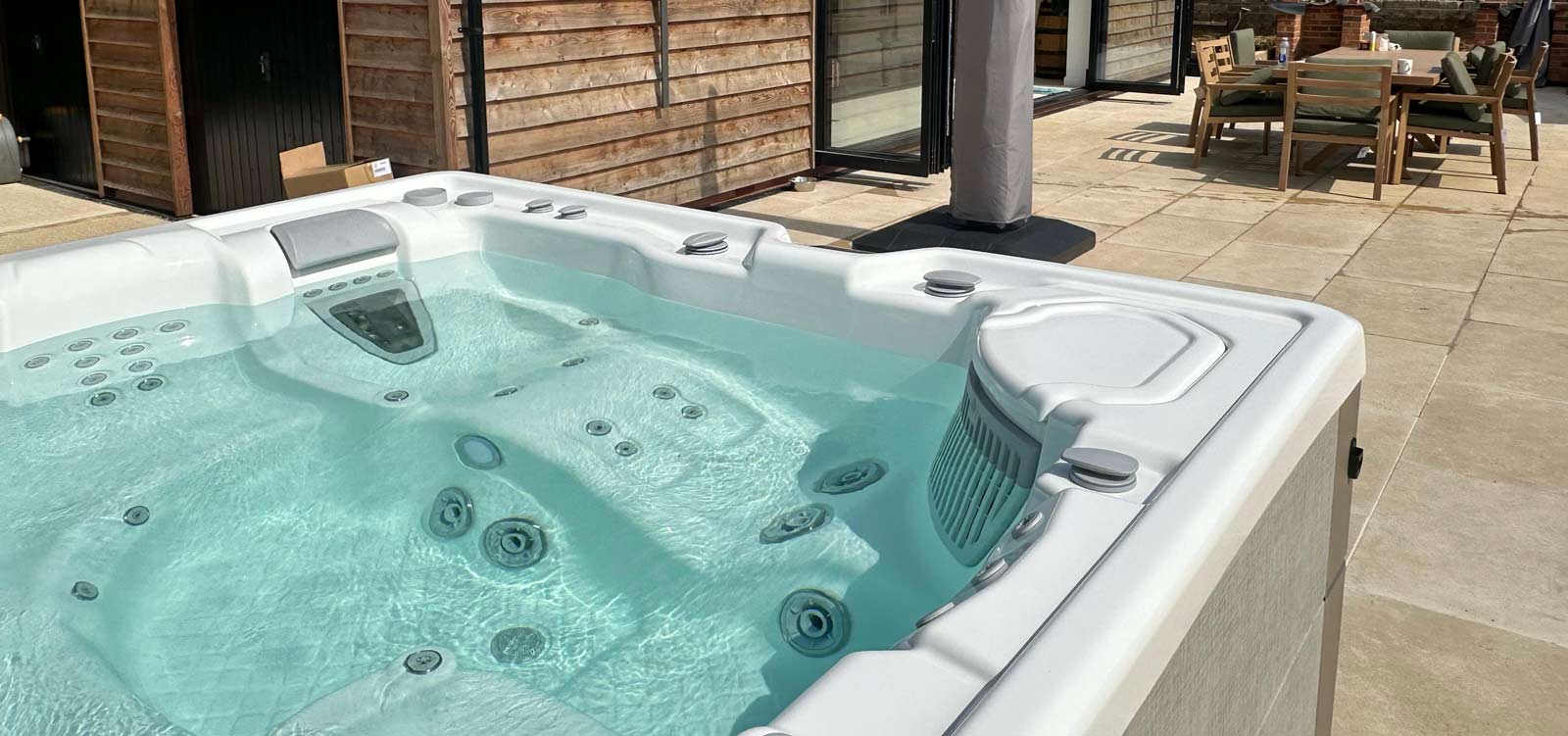A filled hot tub in a garden