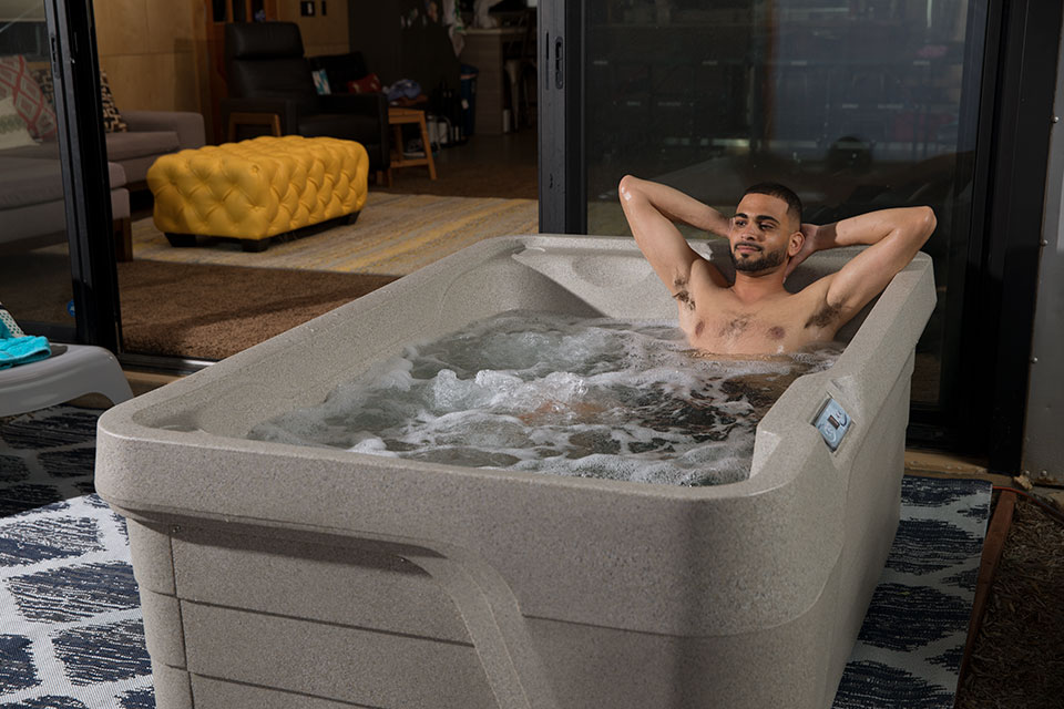 man enjoys hot tub on holiday