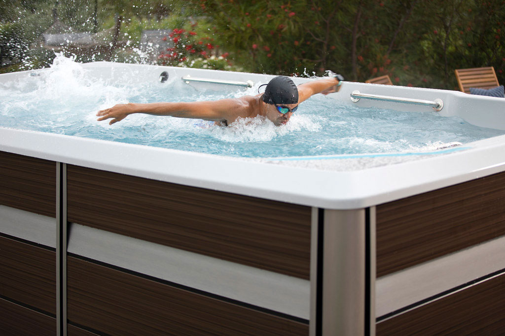 A swimmer performing buterfly stroke in an e-series endless pool