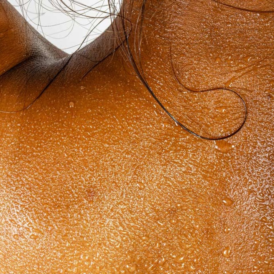 beads of sweat on a woman's back