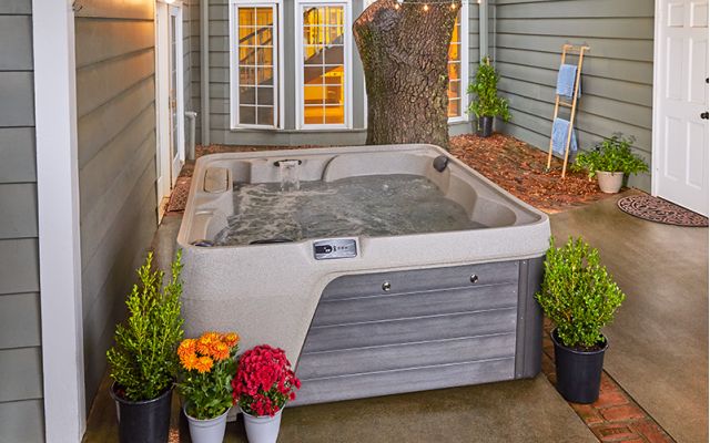 Woman in freeflow hot tub looking at sunset