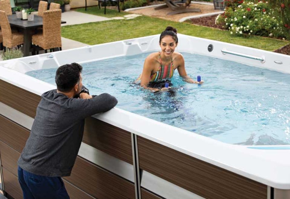woman swims in swim spa