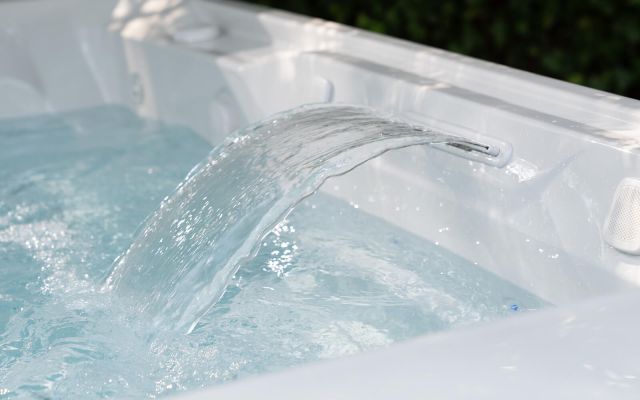 View of a Limelight Flair hot tub with a garden pool in the background