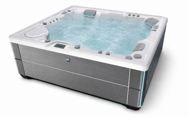 A product shot of a HotSpring Highlife hot tub filled with water and isolated against a white background