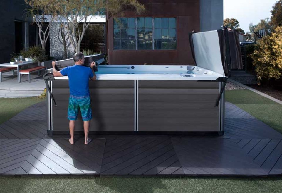 man closes roof on swim spa