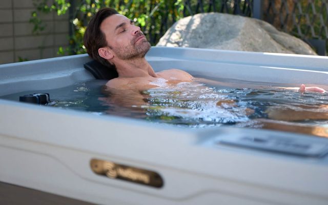 A man relaxing in a Freeflow Mini hot tub