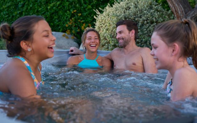 woman relaxes in freeflow hot tub