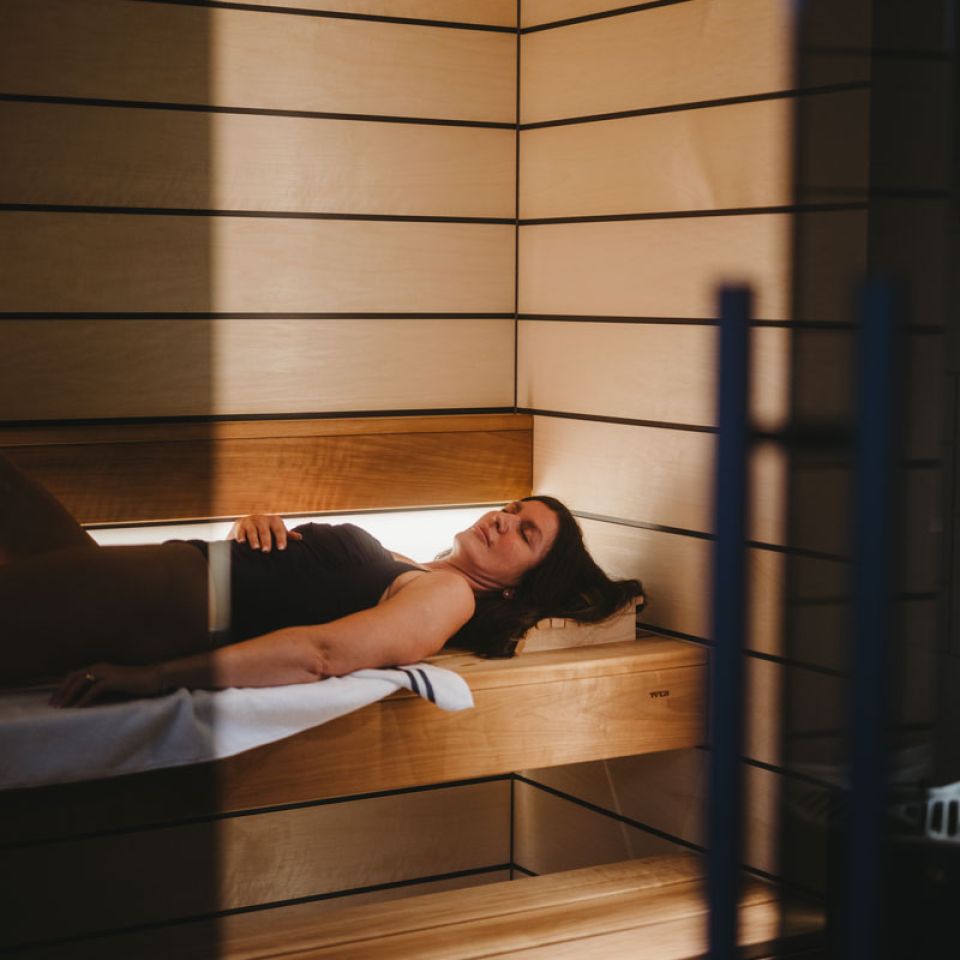 A woman lying in a sauna