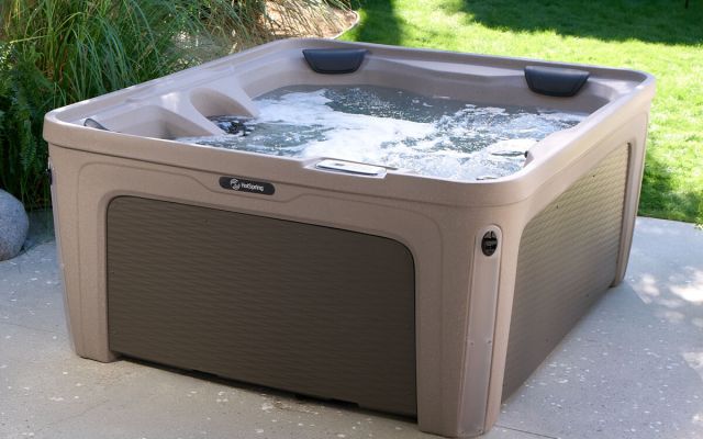 woman relaxes in freeflow hot tub