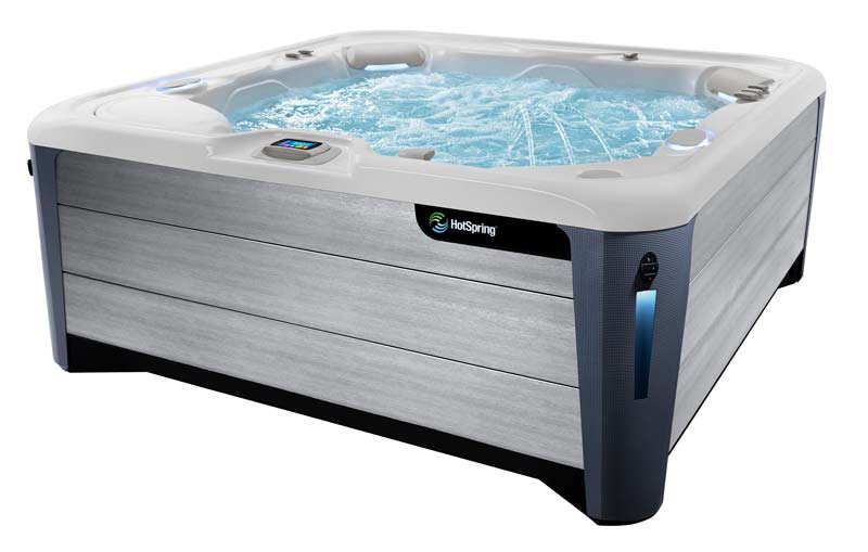 A product shot of a HotSpring Highlife hot tub filled with water and isolated against a white background