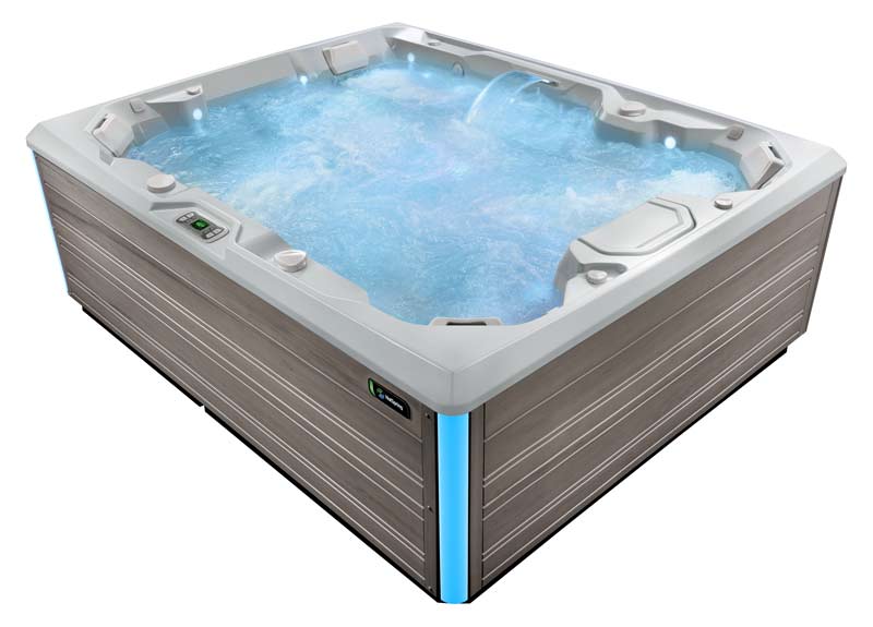 A product shot of a HotSpring Limelight hot tub filled with water and isolated against a white background