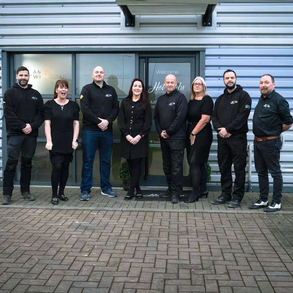A group shot outside the front door of the showroom, with (from left to right) Barry, Natalie, Kenny, Carla, Phil, Lorraine, Ross, and Chris