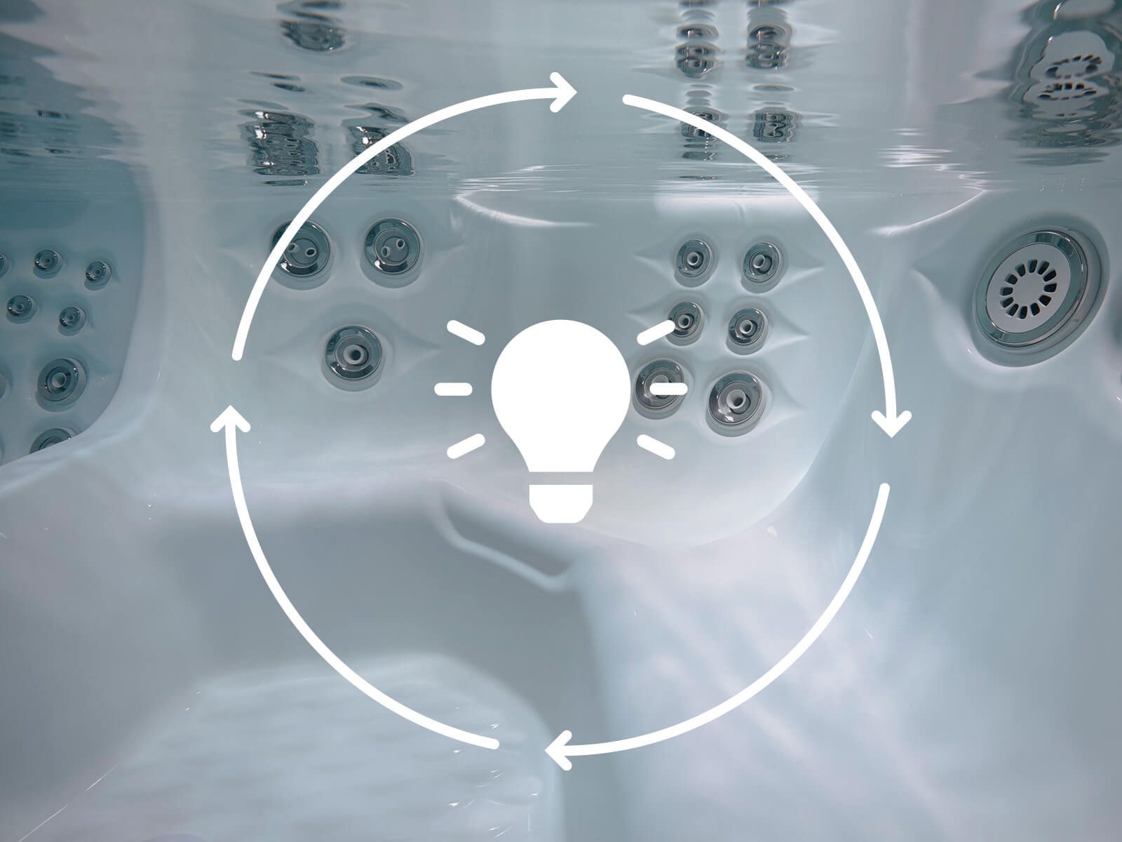 A lighbulb icon within a graphic of a rotating circle, overlaid on an image of a hot tub to signify the low energy cost of this component.